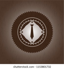 necktie icon inside badge with wood background