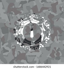 necktie icon inside grey camouflaged emblem