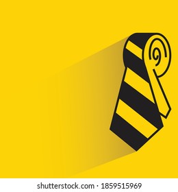 necktie with shadow on yellow background