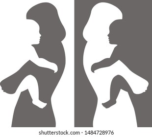 Negative space cut out silhouette of a mother carrying a baby or a toddler in her arms