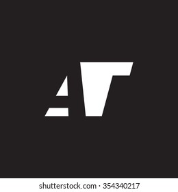 AT negative space letter logo black background
