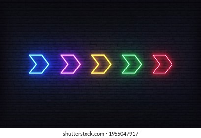Neon arrow sign. Set of colorful futuristic glowing neon arrow pointer on brick wall background
