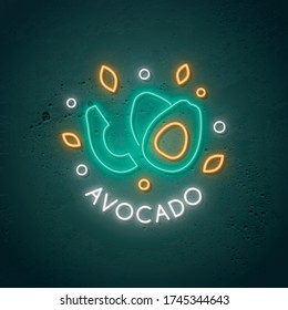 Neon Avocado sign. Glowing avocado fruit emblem in neon style. Stock vector illustration.