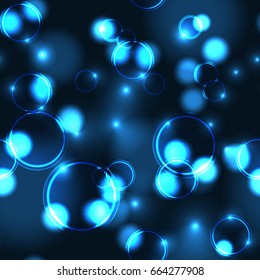 Neon blue bokeh effect seamless pattern. Dark background with Glowing sparkling circles and rings in blue colors. 