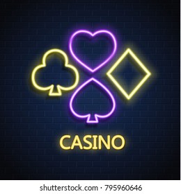 Neon casino sign. Poker, blackjack card suits, spade diamond heart club. Gambling Las Vegas glowing singage banner advertising template design. Gambling game vector illustration brick wall background