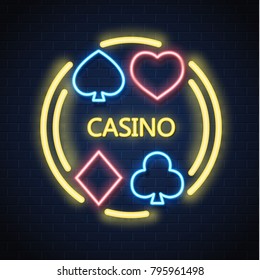 Neon casino sign. Poker, blackjack card suits, spade diamond heart club. Gambling light lamp glowing singage banner advertising template design. Gambling game vector illustration brick wall background