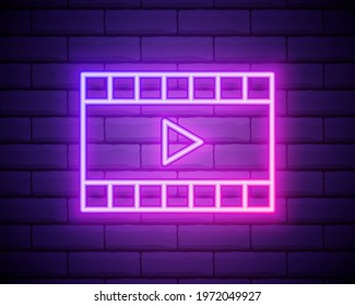 Neon cinema film in purple and violet color. Vector illustration of cinema film with Play icon consisting of neon outlines, with backlight on the dark brick wall background.