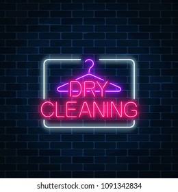 Neon dry cleaning glowing sign with hanger on a dark brick wall background. Cleaning service signboard design. Vector illustration