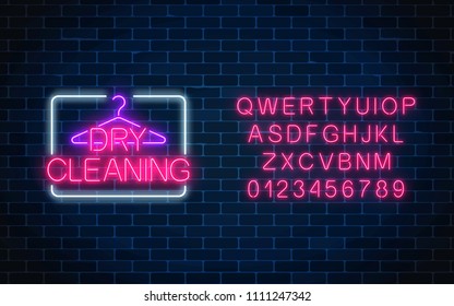 Neon dry cleaning glowing sign with hanger and alphabet template on a dark brick wall background. Cleaning service signboard design. Vector illustration