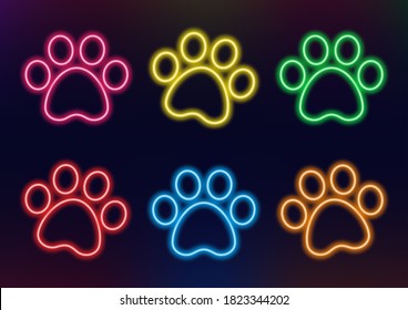 Neon frame. Set of neon animal paws in different colors. Laser glowing lines on a dark background.