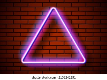 Neon frame with triangle shape on the red brick wall. Classic rectangular 80s styled shiny glowing neon sign.