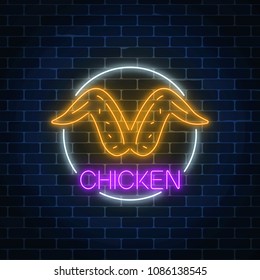 Neon glowing sign of chicken wings in circle frame on a dark brick wall background. Fastfood light billboard symbol. Cafe menu item. Vector illustration.