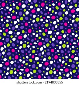 Neon handwritten polka dots wallpaper. Patterned speckled dots of bright green, pink on dark blue background. Seamless mottled fabric. Small circles of simple round shape hand drawn for cover design.