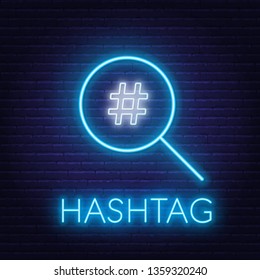 Neon hashtag search sign on brick wall background.