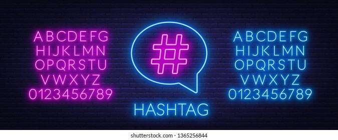 Neon hashtag sign in speech bubble on brick wall background. Neon alphabet