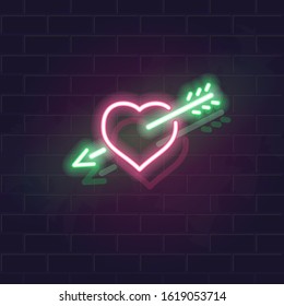 Neon heart and arrow vector icon on brick wall background. Fall in love symbol for st. valentines day poster, flyer, party, banner or social network post.