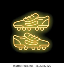 Neon icon of football shoes glowing in yellow light on a black background