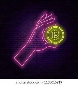 Neon illustration the hand holding a symbol bitcoin. The shining banner in a retro style. An element for design. Concept of the transaction with cryptocurrency. Vector illustration.