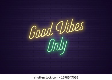 Neon lettering of Good Vibes Only. Glowing headline, bright neon cursive text of Good Vibes Only. Title template for web banner and poster. Yellow and green color