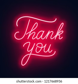 Neon lettering thank you on a dark background.