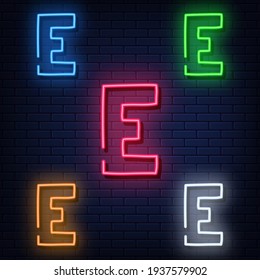 Neon letters, five colors: red, blue, green, yellow, white. Isolated font on a blue brick wall background. Vector illustration eps 10.