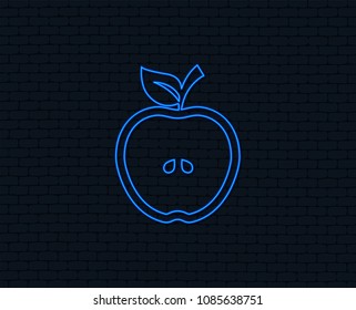 Neon light. Apple sign icon. Fruit with leaf symbol. Glowing graphic design. Brick wall. Vector