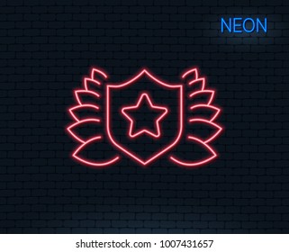 Neon light. Award shield line icon. Laurel wreath symbol. Laureate sign. Glowing graphic design. Brick wall. Vector