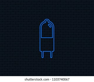 Neon light. Light bulb icon. Lamp G4 socket symbol. Led or halogen light sign. Glowing graphic design. Brick wall. Vector