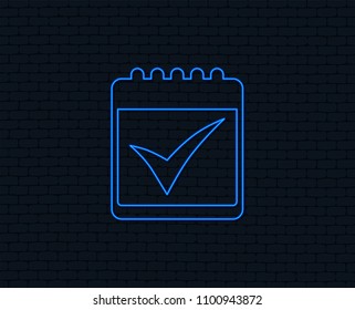 Neon light. Calendar sign icon. Check mark symbol. Glowing graphic design. Brick wall. Vector