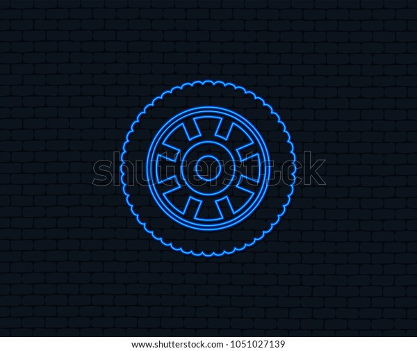 Neon light.\
Car wheel sign icon. Circular transport component symbol. Glowing\
graphic design. Brick wall.\
Vector