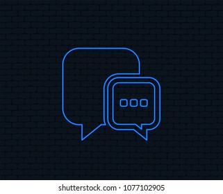 Neon light. Chat sign icon. Speech bubble with three dots symbol. Communication chat bubble. Glowing graphic design. Brick wall. Vector