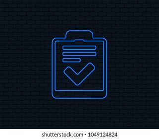 Neon light. Checklist sign icon. Control list symbol. Survey poll or questionnaire feedback form. Glowing graphic design. Brick wall. Vector