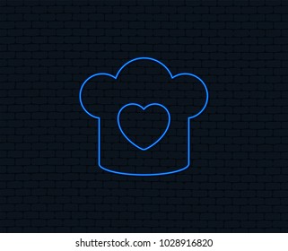 Neon light. Chef hat sign icon. Cooking symbol. Cooks hat with heart love. Glowing graphic design. Brick wall. Vector
