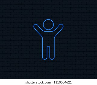 Neon light. Child icon. Happy young boy symbol. Person silhouette. Glowing graphic design. Brick wall. Vector