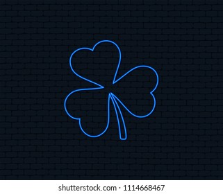 Neon light. Clover with three leaves sign icon. Trifoliate clover. Saint Patrick trefoil symbol. Glowing graphic design. Brick wall. Vector