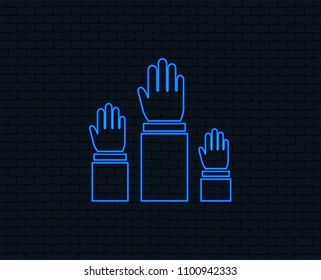 Neon light. Election or voting sign icon. Hands raised up symbol. People referendum. Glowing graphic design. Brick wall. Vector