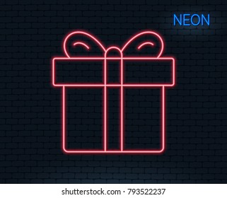 Neon light. Gift box line icon. Present or Sale sign. Birthday Shopping symbol. Package in Gift Wrap. Glowing graphic design. Brick wall. Vector