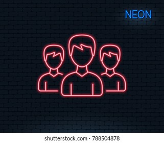 Neon light. Group line icon. Users or Teamwork sign. Male Person silhouette symbol. Glowing graphic design. Brick wall. Vector