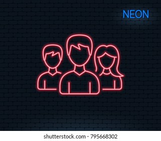 Neon light. Group line icon. Users or Teamwork sign. Male and Female Person silhouette symbol. Glowing graphic design. Brick wall. Vector