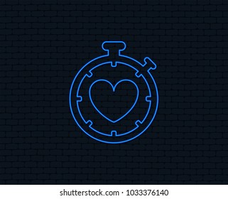 Neon light. Heart Timer sign icon. Stopwatch symbol. Heartbeat palpitation. Glowing graphic design. Brick wall. Vector