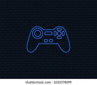 Neon light. Joystick sign icon. Video game symbol. Glowing graphic design. Brick wall. Vector