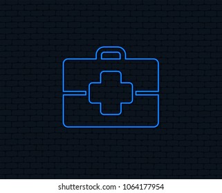 Neon light. Medical case sign icon. Doctor symbol. Glowing graphic design. Brick wall. Vector