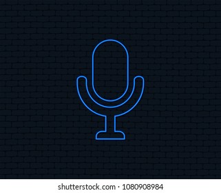 Neon light. Microphone icon. Speaker symbol. Live music sign. Glowing graphic design. Brick wall. Vector