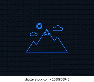 Neon light. Mountain icon. Mountaineering sport sign. Leadership motivation concept. Glowing graphic design. Brick wall. Vector