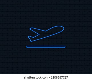 Neon light. Plane takeoff icon. Airplane transport symbol. Glowing graphic design. Brick wall. Vector