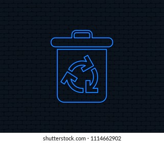 Neon light. Recycle bin icon. Reuse or reduce symbol. Glowing graphic design. Brick wall. Vector