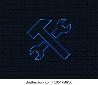 Neon light. Repair tool sign icon. Service symbol. Hammer with wrench. Glowing graphic design. Brick wall. Vector
