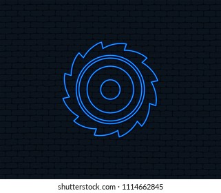 Neon light. Saw circular wheel sign icon. Cutting blade symbol. Glowing graphic design. Brick wall. Vector