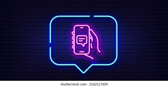 Neon light speech bubble. Chat app line icon. Hand hold phone sign. Cellphone with screen notification symbol. Neon light background. Chat app glow line. Brick wall banner. Vector