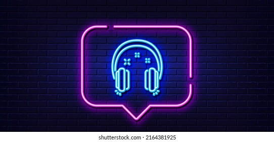 Neon light speech bubble. Headphones line icon. Music listen sign. Musical earphones symbol. Neon light background. Headphones glow line. Brick wall banner. Vector